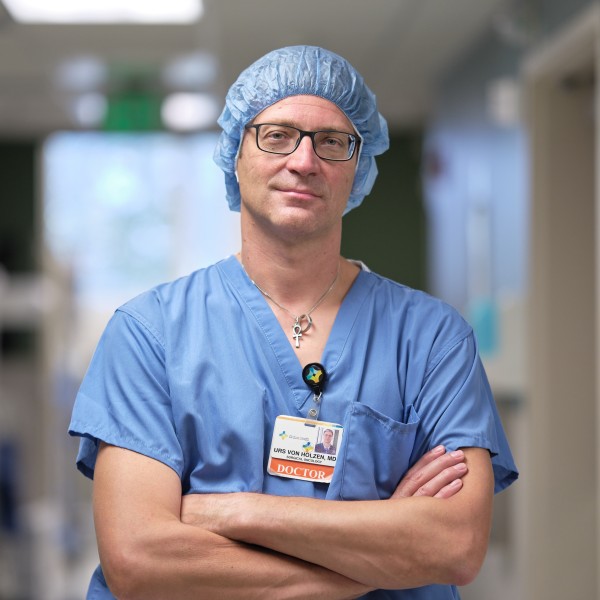 Dr von Holzen, Surgical Oncologist, smiling with arms crossed